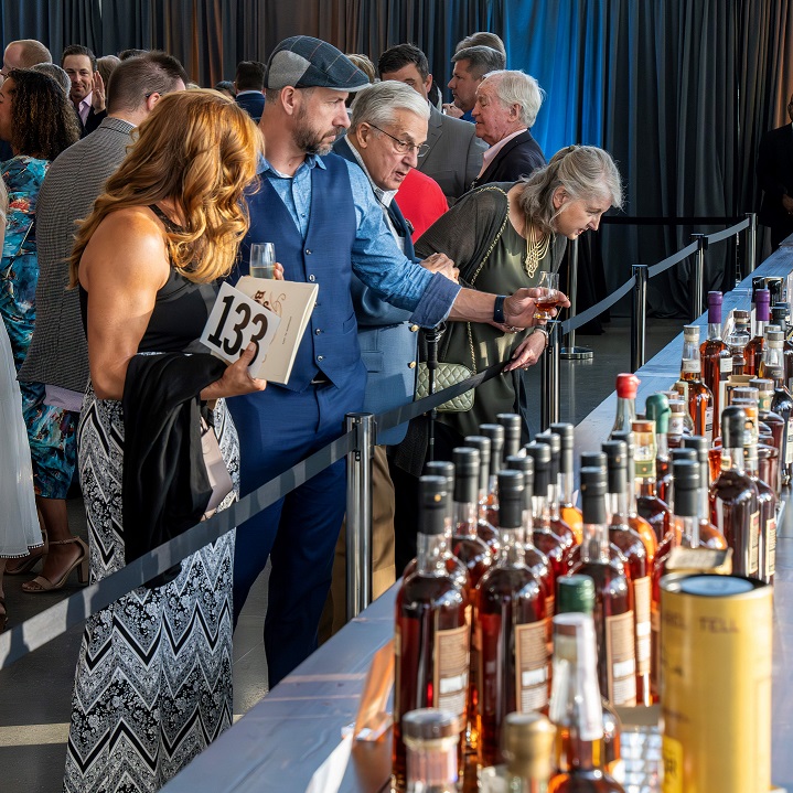 Art of Bourbon Auction bidders and bottles Speed Art Museum