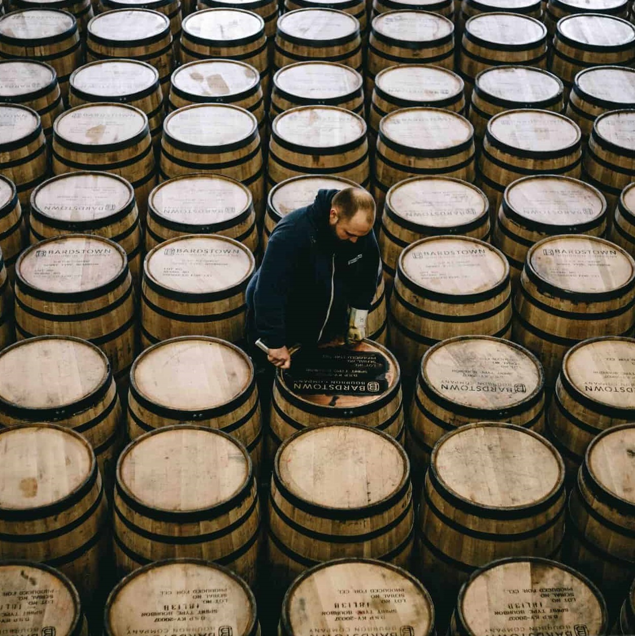 Bardstown Bourbon Company barrel leasing man on barrels